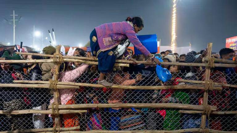 A devotee crosses over a barricade, after a deadly stampede before the second “Shahi Snan” (royal bath), at the “Maha Kumbh Mela” or the Great Pitcher Festival in Prayagraj - REUTERSpix