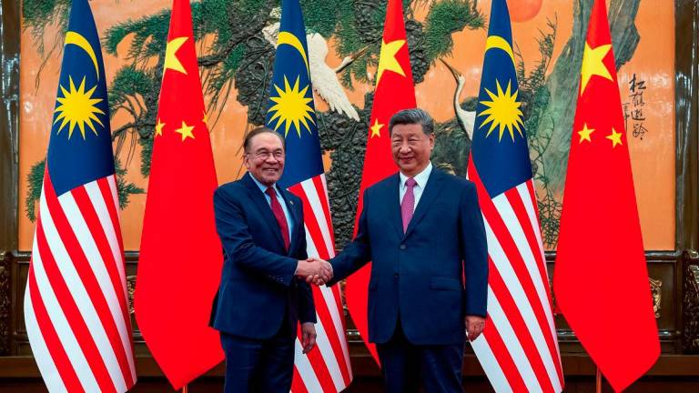 Malaysian Prime Minister Datuk Seri Anwar Ibrahim meets Chinese President Xi Jinping during a courtesy call at the Great Hall of the People here on Tuesday. - BERNAMAPIX
