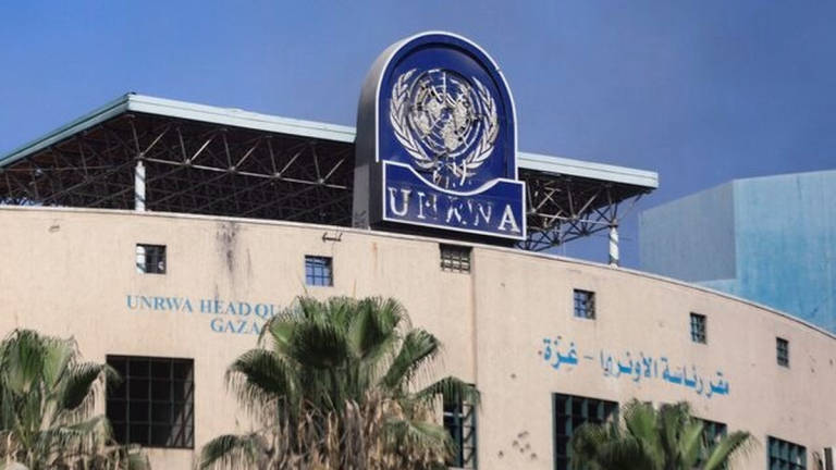 A damaged sign is pictured at the headquarters of UNRWA, following an Israeli raid, amid the Israel-Hamas conflict, in Gaza City, July 12, 2024. - REUTERS