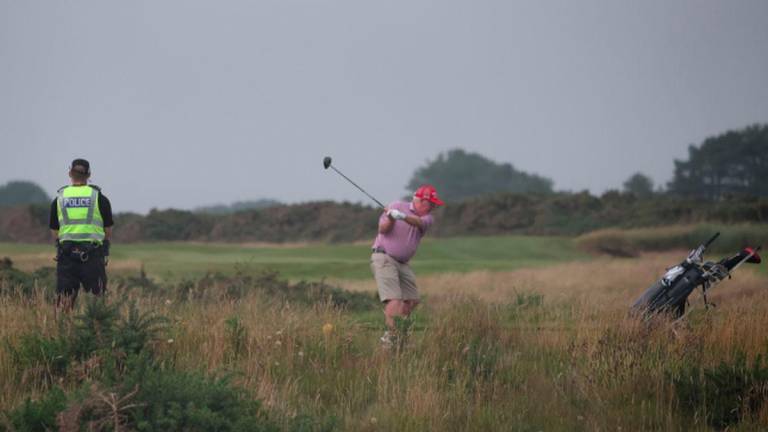 A police officer watches a golfer tee off on a hole on the Trump Turnberry golf course ahead of the expected arrival of U.S.President Donald Trump later this week in Turnberry, Scotland, Britain, July 24, 2025. - REUTERSPIX
