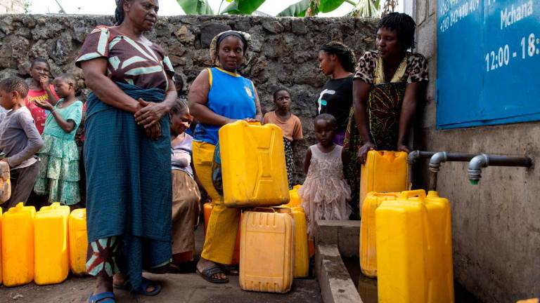 Women and children queue at the standpipe, where incomplete water connections caused by USAID funding cuts to the NGO Mercy Corps have led to ongoing water shortages, in Goma, North Kivu province, Democratic Republic of Congo, June 16, 2025. REUTERS