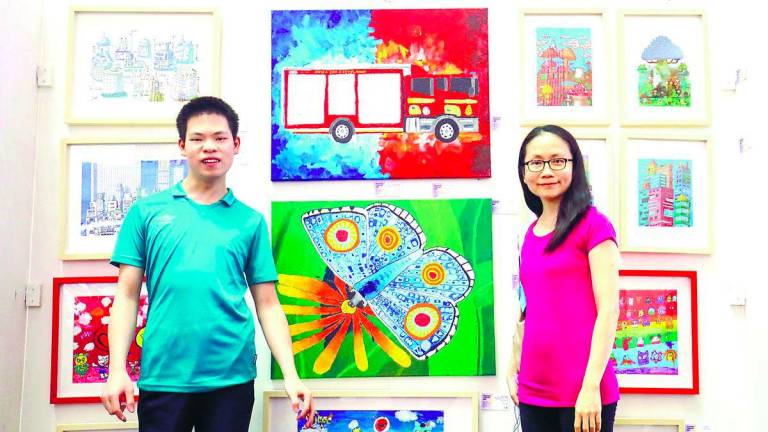 Tay and Sheng at their display booth during the exhibition. – Adib Rawi Yahya/theSun