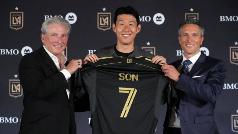 Aug 6, 2025; Los Angeles, California, USA; Son Heung-min (center) poses with LAFC lead managing owner Bennett Rosenthal (left) and general manager John Thorrington during an LAFC introductory press conference at BMO Stadium. [Credit: Kirby Lee-Imagn Images via REUTERS]
