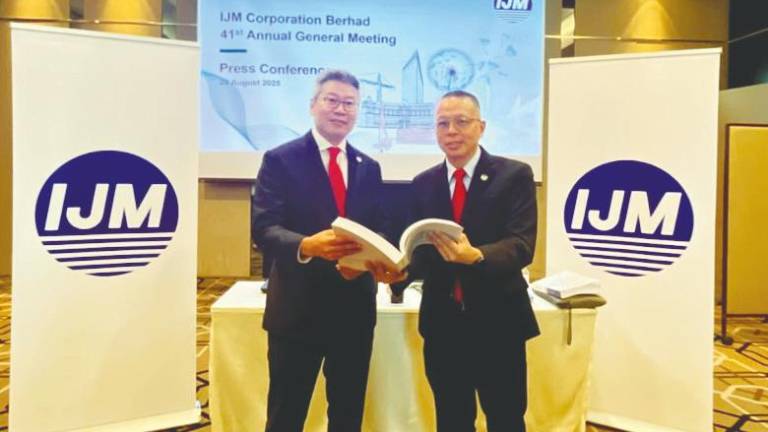 Lee (left) with group chief financial officer Datuk Edward Chong at the press conference after IJM Corporation’s AGM in Kuala Lumpur.
