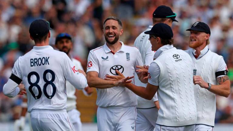 England’s Chris Woakes celebrates taking the wicket of India’s KL Rahul on the opening day of the second cricket test match between England and India at Edgbaston cricket ground in Birmingham, central England on July 2, 2025. (Photo by Darren Staples / AFP)