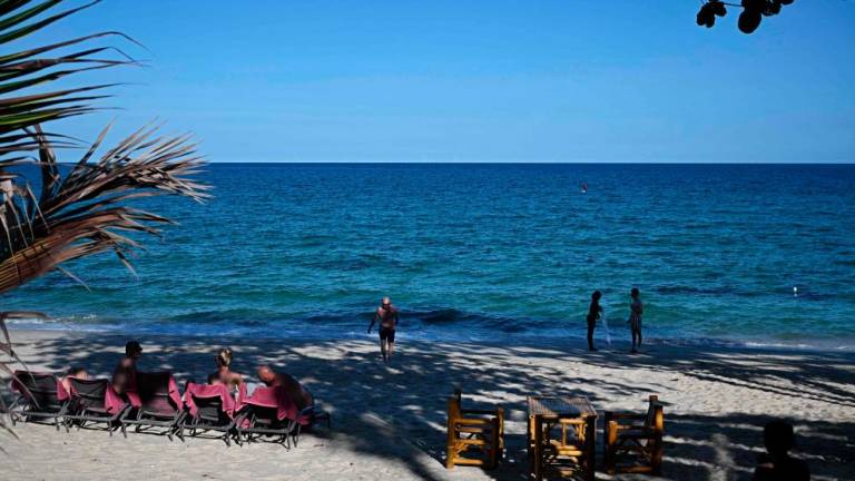 People relax on Lamai beach on Koh Samui island in the southern Thai province of Surat Thani on April 8, 2024/AFPPix