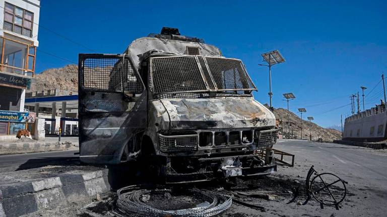 A burnt police vehicle is pictured that was torched by the demonstrators near the Bharatiya Janata Party (BJP) office in Leh on September 25, 2025. (Photo by Tauseef MUSTAFA / AFP)