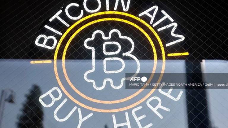 A sign advertises a Bitcoin ATM at a gas station on July 16, 2025 near Pasadena, California. - Mario Tama/Getty Images/AFP