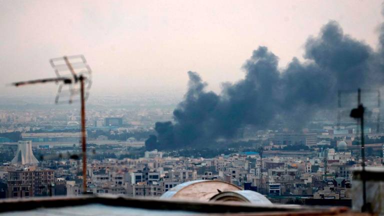 The Islamic Republic of Iran Broadcasting (IRIB) building was struck in an Israeli attack on June 16, cutting live coverage immediately. (Photo by ATTA KENARE / AFP)