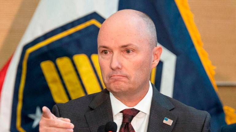 Utah Governor Spencer Cox gestures as he speaks during a press conference announcing details on the suspect in the shooting of U.S. conservative commentator Charlie Kirk, who was fatally shot during an event at Utah Valley University, in Orem, Utah, U.S. September 12, 2025. REUTERS/Cheney Orr TPX IMAGES OF THE DAY