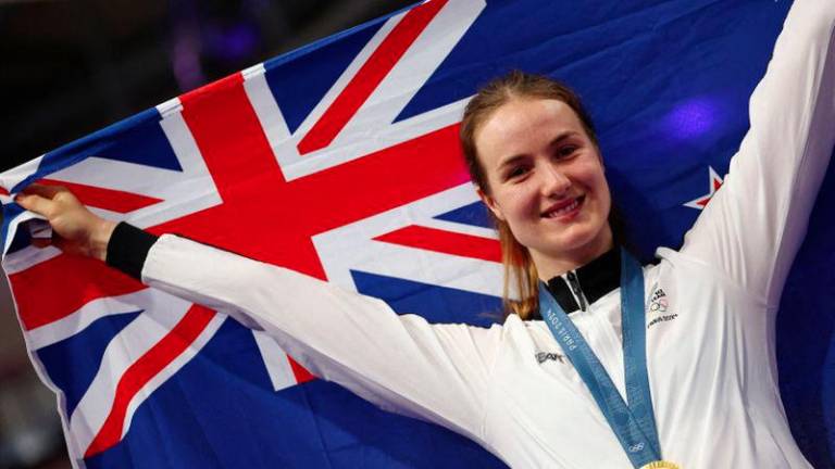 Paris 2024 Olympics - Track Cycling - Women's Sprint, Victory Ceremony - Saint-Quentin-en-Yvelines Velodrome, Montigny-le-Bretonneux, France - August 11, 2024.Gold medallist Ellesse Andrews of New Zealand celebrates on the podium. - REUTERSPIX