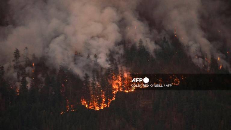 A wildfire burns on Mount Underwood near Port Alberni, on Vancouver Island, British Columbia, on August 12, 2025. - AFP