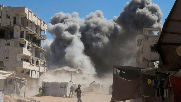 Smoke rises from an evacuated residential building which was housing displaced Palestinians, after it was hit by an Israeli air strike, in Gaza City, September 14, 2025. REUTERS/Ebrahim Hajjaj