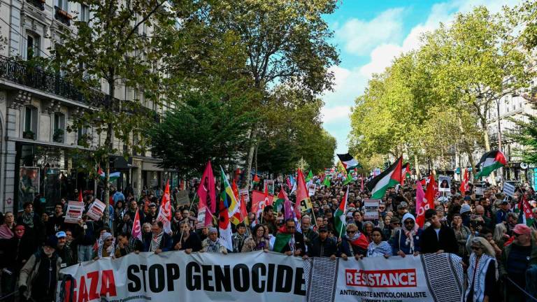 Demonstrators hold a banner reading “Gaza, stop genocide, restistance antisionist, anticolonialist, urgence palestine” during a rally in solidarity with Palestinians and to protest against the interception by the Israeli army of the Global Sumud Flotilla, in Paris on October 4, 2025. (Photo by Anna KURTH / AFP)