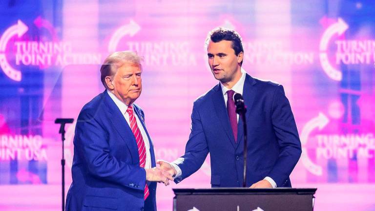 Right-wing activist Charlie Kirk (R) speaks on stage with President Donald Trump at America Fest 2024 in Phoenix, Arizona, on December 22, 2024. Photo by JOSH EDELSON / AFP