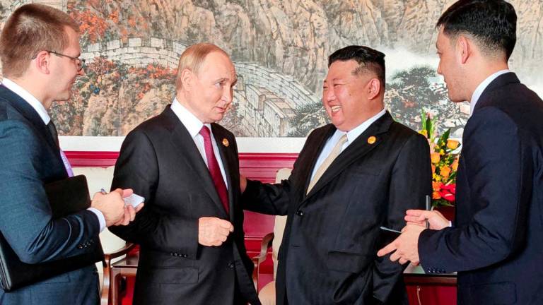 North Korean leader Kim Jong Un speaks with Russian President Vladimir Putin during their visit to Beijing to attend China's commemoration of the 80th anniversary of the end of World War Two, in Beijing, China, September 3, 2025, in this picture released by the Korean Central News Agency. - KCNA via REUTERSPIX