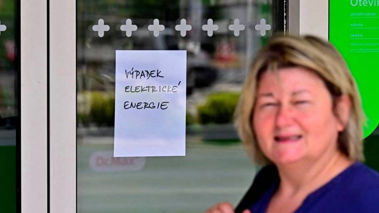 A woman walks past by pharmacy closed due to a major power outage in Usti nad Labem, Czech Republic, July 4, 2025. The text reads Outage of electric energy. - CTK/Hajek Ondrej via REUTERSPIX