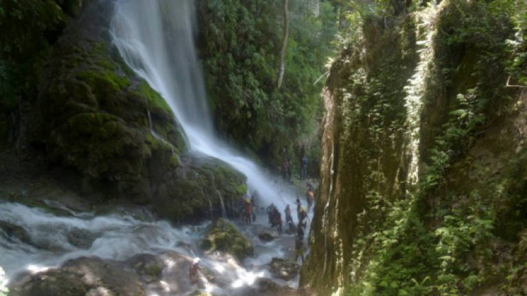 Haiti's pilgrims beseech goddess of love at waterfall