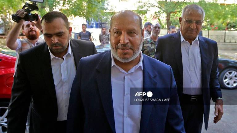 Hamas’s top negotiator Khalil al-Hayya (c) - (Photo by Louai Beshara / AFP)