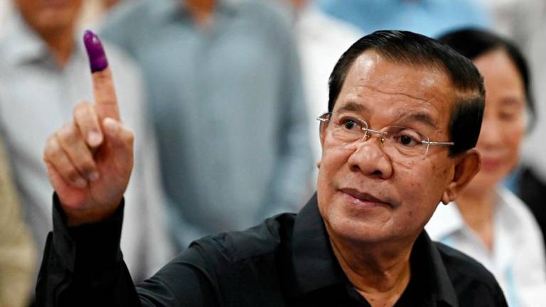Member of parliament and Cambodia's former prime minister Hun Sen shows his inked finger after voting at a polling station during the Senate election in Takhmao city, Kandal province on February 25, 2024. - AFPPIX