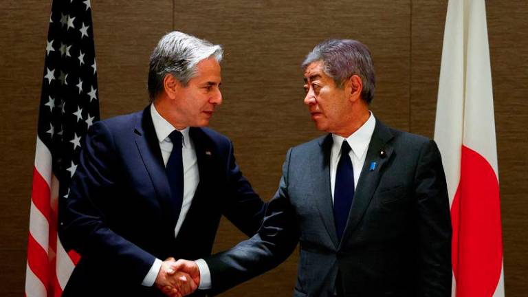 US Secretary of State Antony Blinken (L) shakes hands with Japanese Foreign Minister Takeshi Iwaya during a working lunch at a hotel in Tokyo on January 7, 2025. - AFPPIX