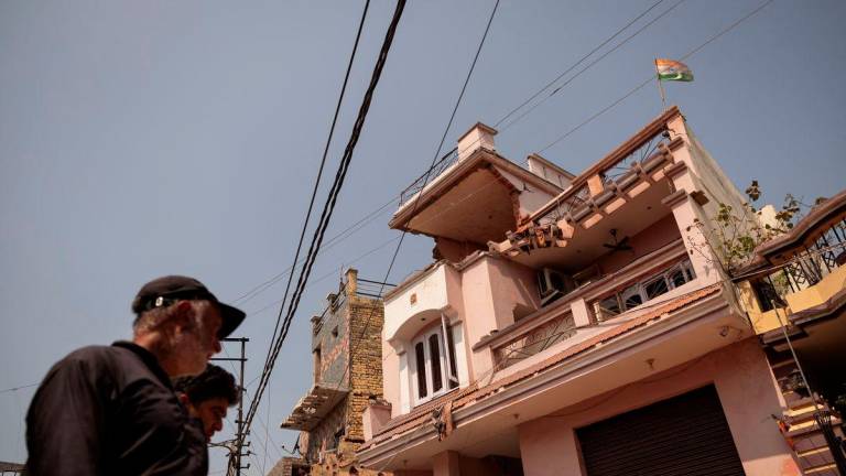 An Indian flag is seen on top of a damaged house, following Pakistan's military operation against India, in Rehari, Jammu, May 10, 2025. - REUTERSPIX