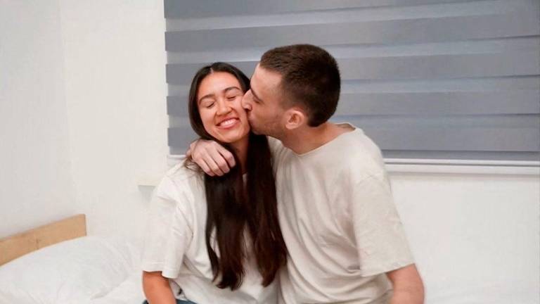 Released Israeli hostage, Avinatan Or, held in Gaza since the deadly October 7, 2023 attack by Hamas, kisses his girlfriend, Noa Argamani, who was also taken hostage and rescued in 2024, after his release as part of a prisoner-hostage swap and a ceasefire deal between Israel and Hamas, in Reim, Israel October 13, 2025. - Courtesy of Israel Defense Forces/Handout via REUTERSPIX