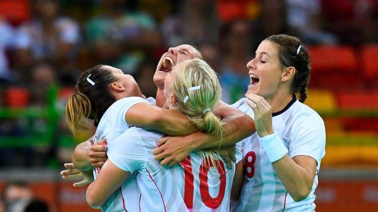 Norwegian players celebrate their victory at the end of the women's preliminaries Group A handball match Spain vs Norway for the Rio 2016 Olympics Games at the Future Arena in Rio on August 8, 2016. - AFPPIX
