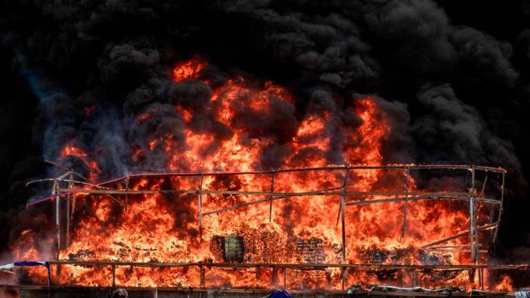 Smoke rises during a destruction ceremony of seized illegal drugs in Yangon on June 26, 2025. (Photo by Sai Aung Main / AFP)