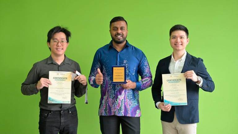 Gunalaan, alongside his team members Ng Wi Liam (left) and Cheng Zhi Qin (right) from the Bachelor of Construction Management and Economics (Hons) programme at TAR UMT, proudly displaying the Second Runner-Up and Gold Award certificates, plaque, and medal from BIIIC 2024.