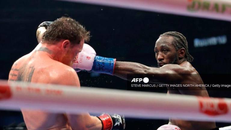 Terence Crawford (R) lands a left on Canelo Alvarez in their undisputed super middleweight title fight during Netflix's Canelo v Crawford Fight Night at Allegiant Stadium on September 13, 2025 in Las Vegas, Nevada. - Getty Images via AFP