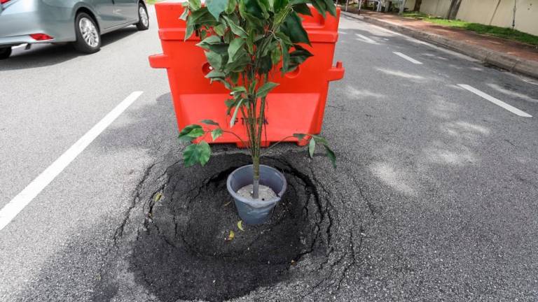 Many road users have suffered vehicle damage, bodily injuries, and some have even lost their lives due to long-unrepaired potholes and road iron covers that sit lower than the road surface. – THESUN