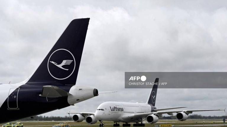 The logo of German airline Lufthansa is seen on the tail of the aircraft as a plane of the same airline lands at Munich International Airport, Munich, southern Germany on April 12, 2023. - AFP