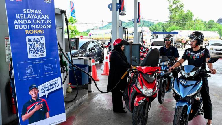 Orang ramai menikmati manfaat inisiatif BUDI MADANI RON95 (BUDI95) apabila dapat mengisi minyak pada harga baharu RM1.99 seliter di sebuah stesen minyak di Chendering, hari ini. -fotoBERNAMA
