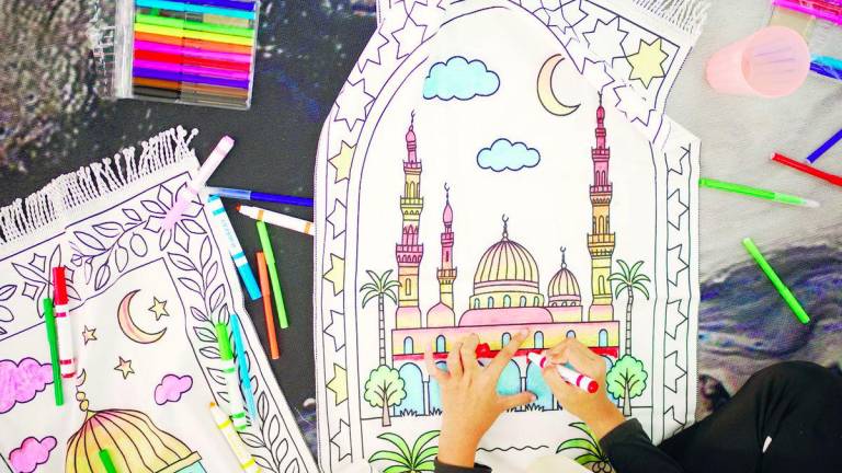 The interactive prayer mats that children can colour while learning about sacred Islamic landmarks. – Pic courtesy of The Bayan Collection