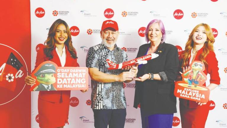 Fareh (left) and Cahill, flanked by AirAsia staff, at the launch of Kuala Lumpur-Darwin route by AirAsia Malaysia at Darwin Airport today.