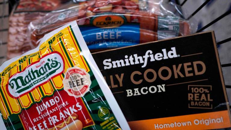 In this photo illustration, meat products by Smithfield Foods are offered for sale at a grocery store - Photo by SCOTT OLSON / GETTY IMAGES NORTH AMERICA / AFP
