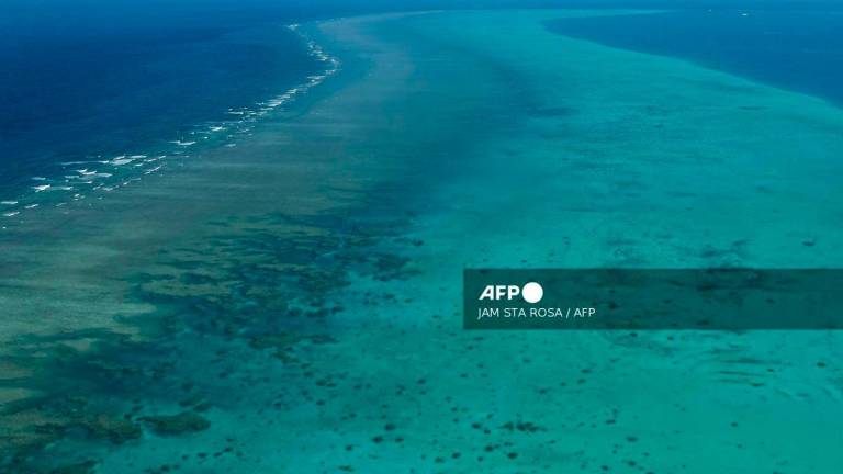 (FILES) This photo taken on February 15, 2024 shows an aerial view over the Scarborough Shoal in the disputed South China Sea. The Philippines protested on September 11, 2025 against a Chinese scheme to create a “nature reserve” on the disputed Scarborough Shoal, the site of repeated clashes in the South China Sea. (Photo by JAM STA ROSA / AFP)