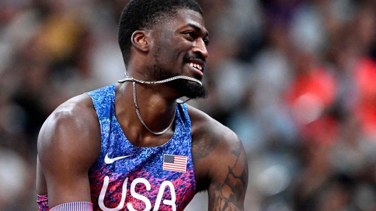 US’ athlete Cordell Tinch celebrates after winning the men’s 110m hurdles final. - Jewel SAMAD / AFP