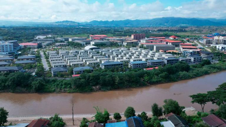 This aerial photo taken on September 17, 2025 shows the KK Park complex in Myanmar’s eastern Myawaddy township, as pictured from Mae Sot district in Thailand’s border province of Tak. - Lillian SUWANRUMPHA / AFP