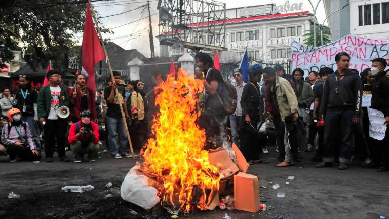 Protesters gather near items being burned outside the regional parliament building during a protest against the government's spending priorities, such as enhanced perks for lawmakers, in Bandung, West Java province, Indonesia, September 1, 2025. - REUTERSPIX
