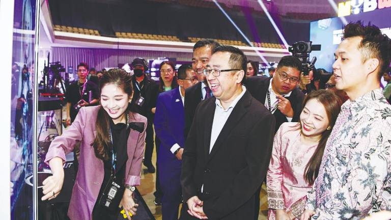 Chang (third, right) being briefed on an exhibit following the launch of Malaysia Blockchain Infrastructure during Malaysia Blockchain Week 2025 being held at the World Trade Centre Kuala Lumpur. – Bernamapic