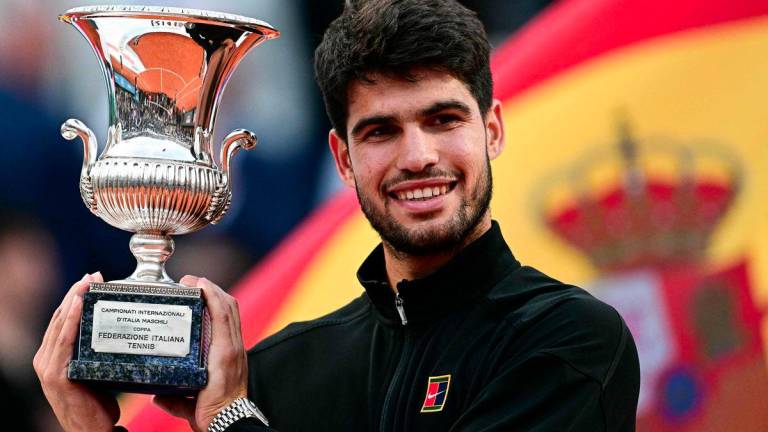 Spain's Carlos Alcaraz shows his winner trophy at the end of his men's singles final match against Italy's Jannik Sinner for the ATP Rome Open tennis tournament at Foro Italico in Rome on May 18, 2025. - AFPPIX