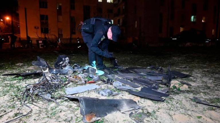 A police expert examines fragments after a drone strike on Kharkiv on May 3, 2025. AFPpix