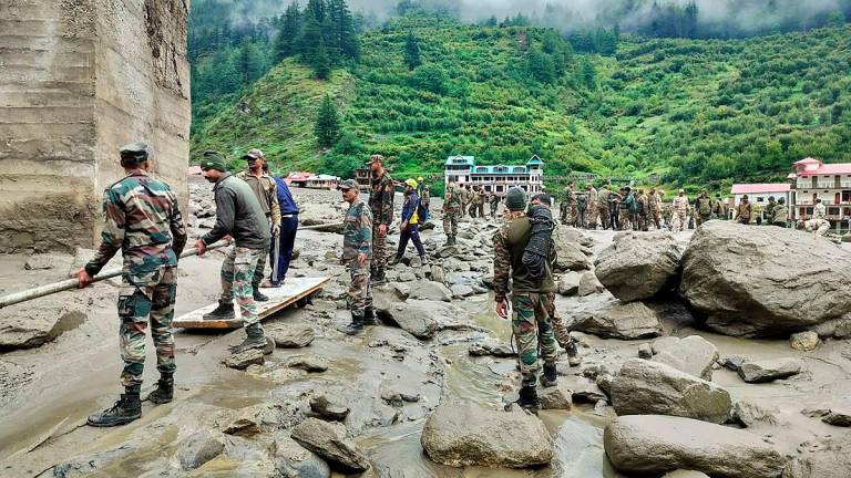 This handout photograph released on August 6, 2025 by the Indian Army shows security and relief personnel building a crossing across a stream of dense sludge during a search and rescue operation, a day after a cloudburst caused a massive mudslide and flash floods in India’s Uttarakhand state. - AFP PHOTO / Indian Army