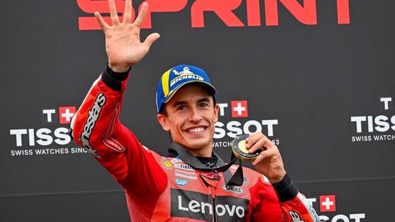 Ducati Lenovo Team’s Spanish rider Marc Marquez celebrates his victory with his gold medal after the sprint race ahead of the motorcycle Hungarian Moto GP Grand Prix at the Balaton Park circuit in Balatonfokajar, Hungary, on August 23, 2025. - ATTILA KISBENEDEK / AFP