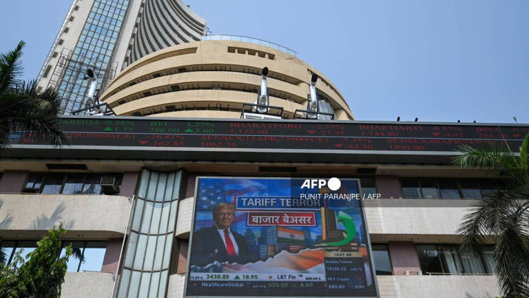A broadcast screen of the Bombay Stock Exchange (BSE) in Mumbai on April 3, 2025, depicts news of US President Donald Trump unveiling sweeping new trade tariffs. - AFP