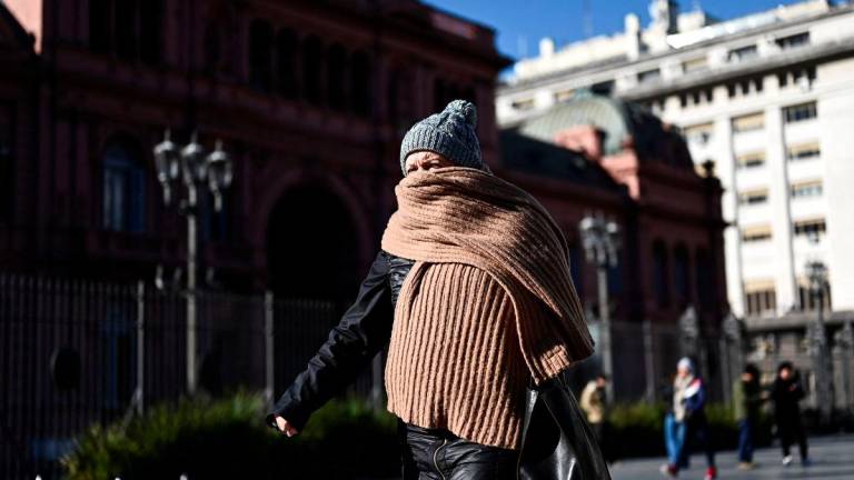 A person walks past Argentina’s Casa Rosada government house on a cold morning, as the temperature drops significantly, in Buenos Aires, Argentina, July 1, 2025. - REUTERSPIX