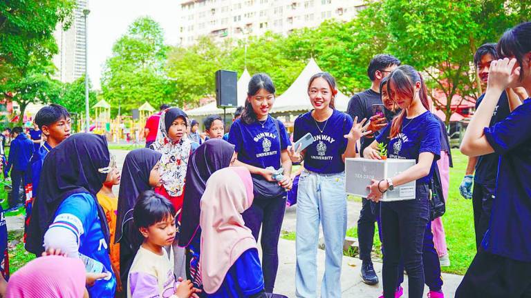 Sunway students have gained considerable insights by working with the B-40 community at Desa Mentari. Mahendhiran (second left) with Sibrandes (third left) sharing insightswith the children at a student engagement session.