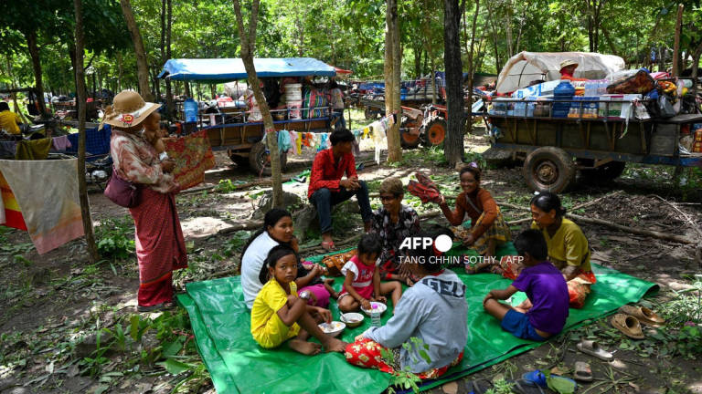 People who fled their homes near the Cambodia-Thailand border rest on the grounds of a pagoda in Oddar Meanchey province on July 25, 2025. - AFP
